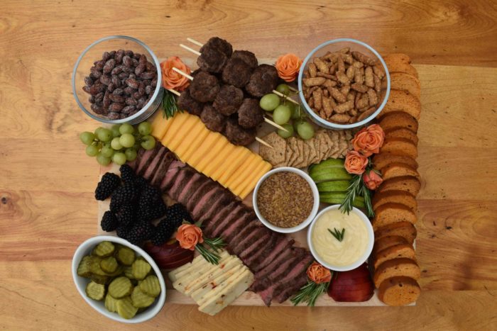 steak charcuterie board with beef cheese fruit and nuts