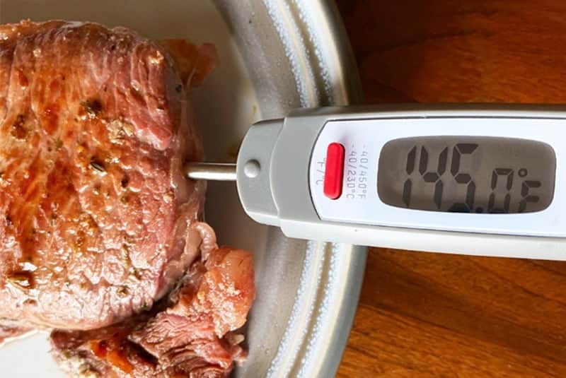 Meat thermometer being placed into grass fed beef